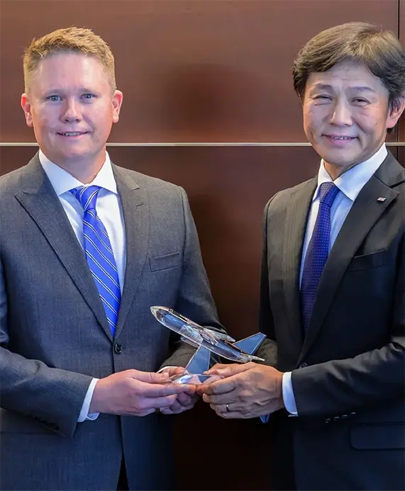 Michael Avery, President and General Manager of 1PointFive and Shinichi Inoue, President and CEO of ANA holding a ceremonial glass airplane