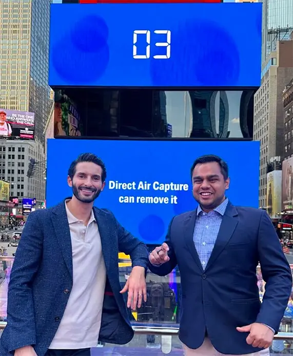 Anthony Cottone and Amil Shah standing in front of 1PointFive billboard in Times Square